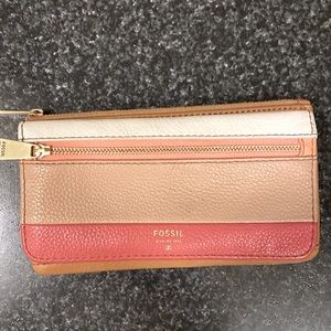 FOSSIL wallet. It’s in a very happy coral, tan and cream color combo.